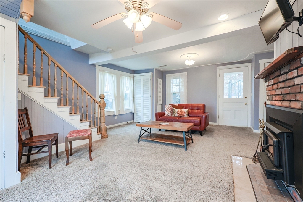 4 Roosevelt Street Wareham, MA 02571 - Photo 10 of 34 a living room with furniture and a chandelier
