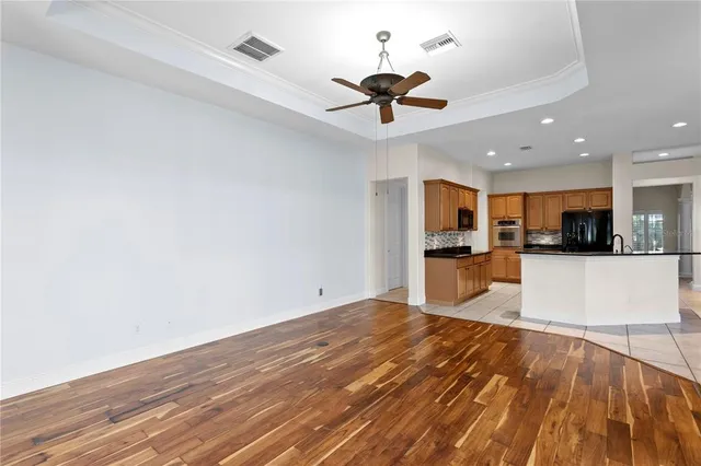 a kitchen with stainless steel appliances granite countertop a sink and a refrigerator