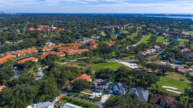 an aerial view of a house with outdoor space and a lake view