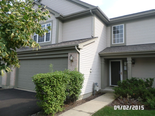 555 Willow Way Lindenhurst, IL 60046 - Photo 1 of 12 a front view of a house with garden