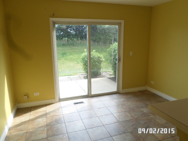 555 Willow Way Lindenhurst, IL 60046 - Photo 6 of 12 a view of an empty room and window