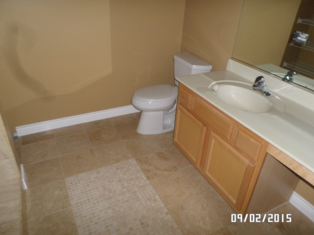 555 Willow Way Lindenhurst, IL 60046 - Photo 7 of 12 a bathroom with a sink and a toilet