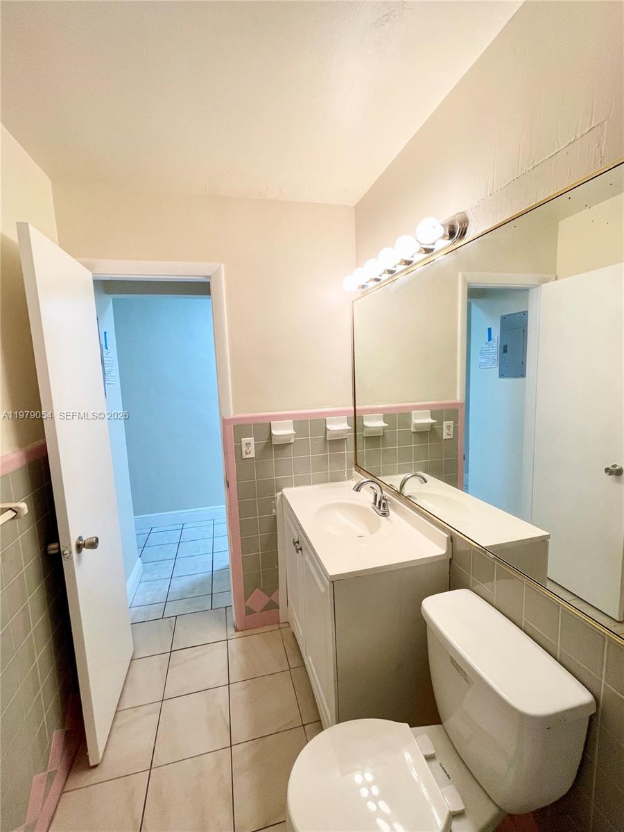 6614 Southwest 20th Street Miramar, FL 33023 - Photo 13 of 28 a bathroom with a sink toilet and mirror