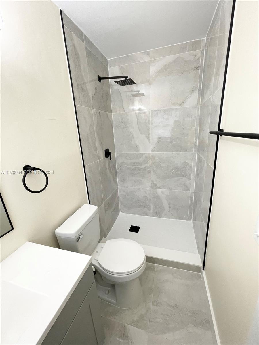 6614 Southwest 20th Street Miramar, FL 33023 - Photo 16 of 28 a bathroom with a toilet and a shower