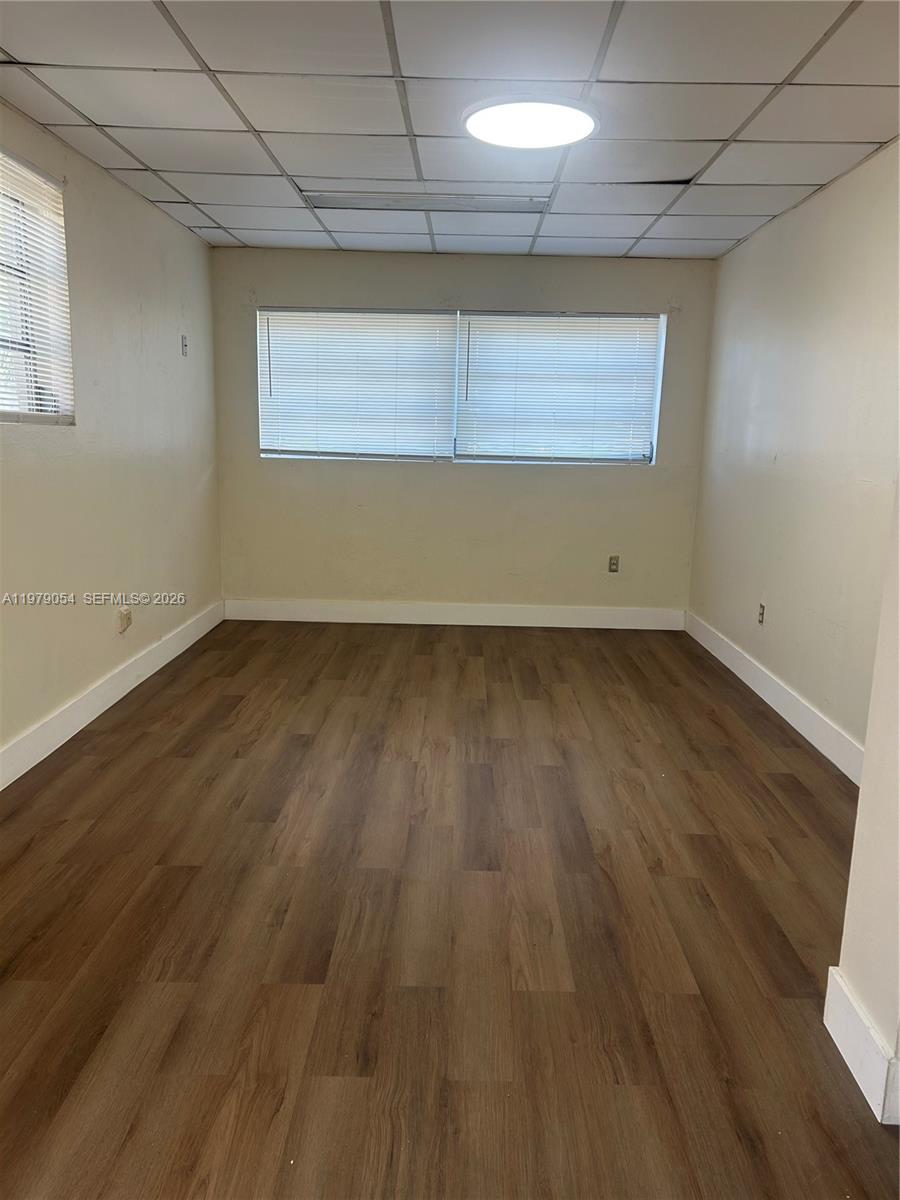 6614 Southwest 20th Street Miramar, FL 33023 - Photo 18 of 28 an empty room with wooden floor and windows