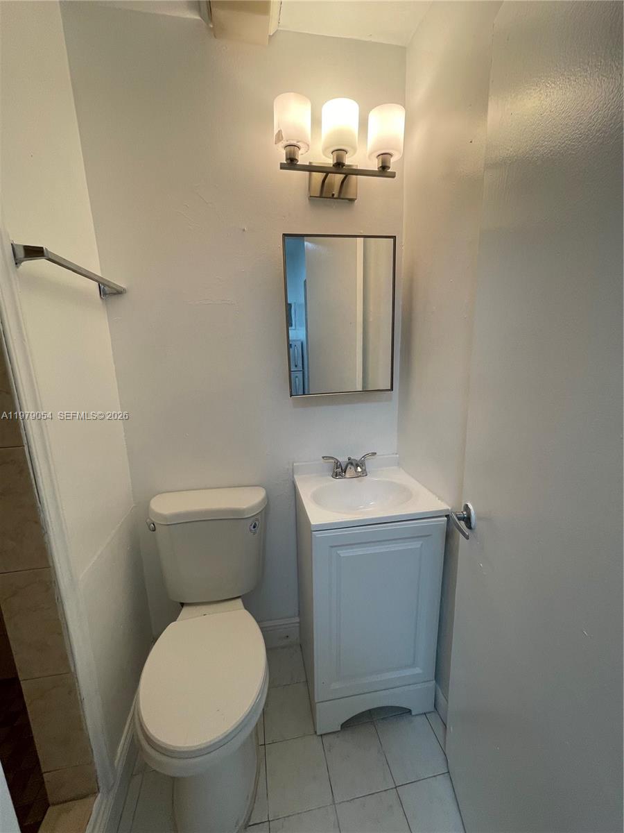 6614 Southwest 20th Street Miramar, FL 33023 - Photo 20 of 28 a bathroom with a toilet sink and mirror