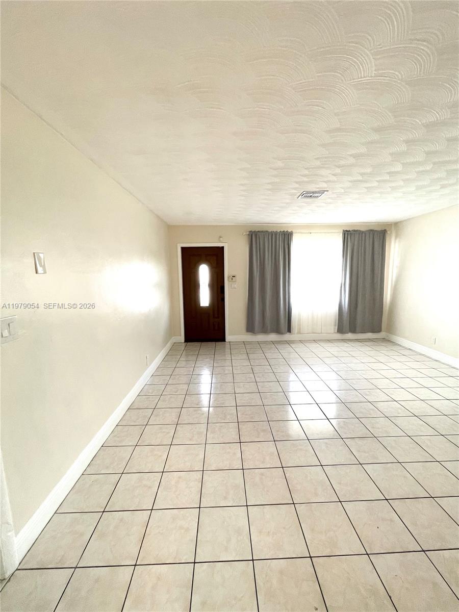 6614 Southwest 20th Street Miramar, FL 33023 - Photo 2 of 28 a view of an empty room and window