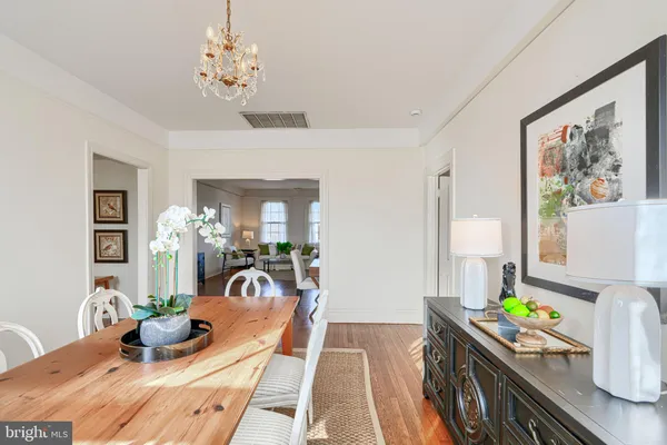 a kitchen with stainless steel appliances white cabinets and wooden floor