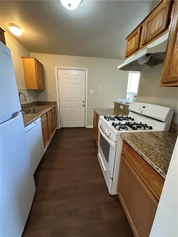 a kitchen with stainless steel appliances granite countertop a stove and a sink