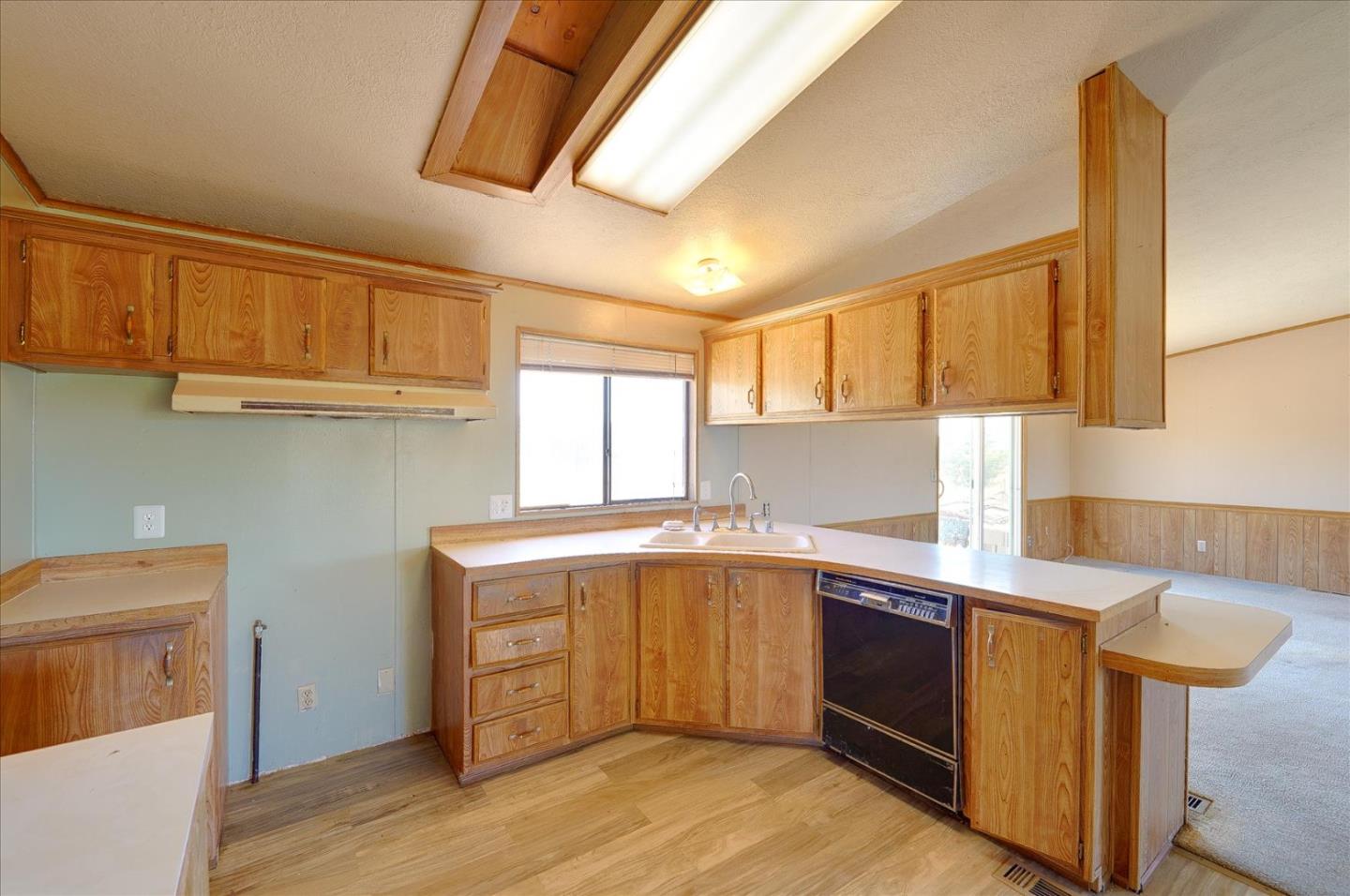 3040 Roop Road Gilroy, CA 95020 - Photo 14 of 63 a kitchen with stainless steel appliances granite countertop a sink a stove a refrigerator cabinets and wooden floor