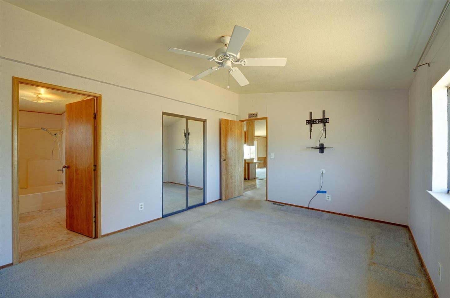 3040 Roop Road Gilroy, CA 95020 - Photo 24 of 63 an empty room with fan and windows