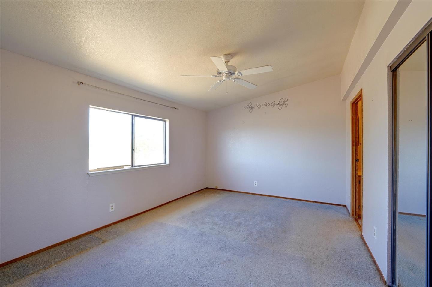 3040 Roop Road Gilroy, CA 95020 - Photo 25 of 63 en empty room with windows and ceiling fan