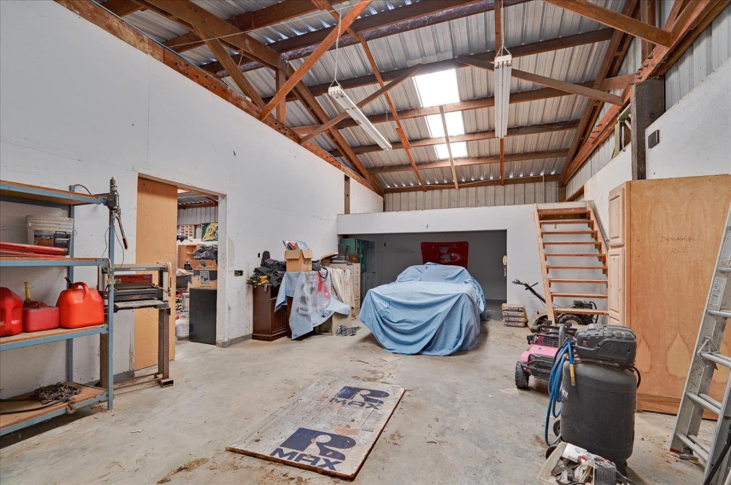3040 Roop Road Gilroy, CA 95020 - Photo 41 of 63 a room with lots of furniture and a chandelier