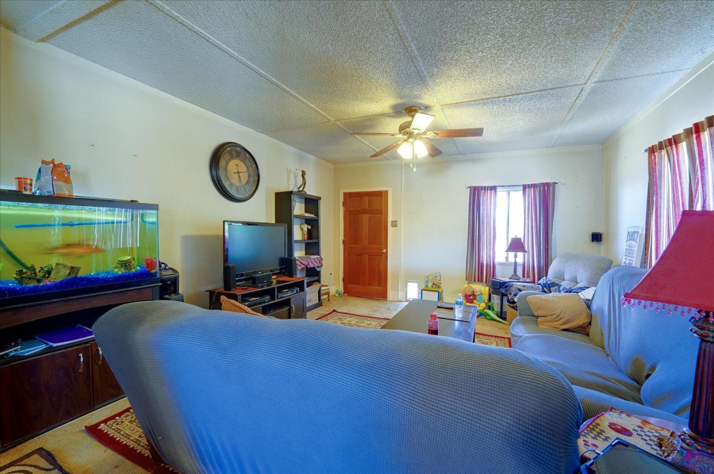 3040 Roop Road Gilroy, CA 95020 - Photo 8 of 63 a living room with furniture a window and a flat screen tv
