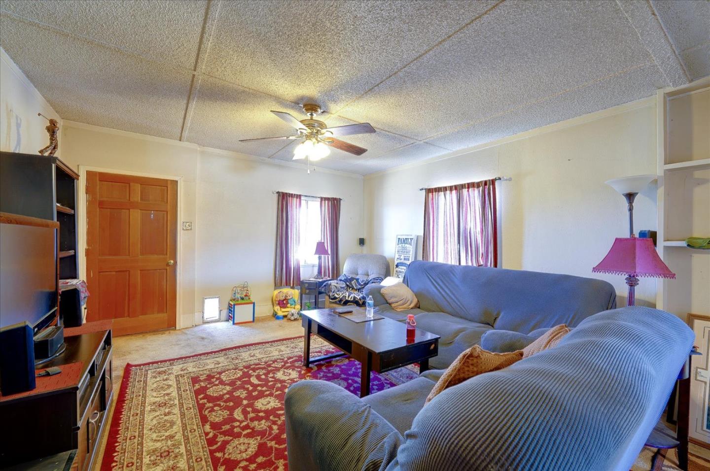3040 Roop Road Gilroy, CA 95020 - Photo 9 of 63 a living room with furniture ceiling fan and a rug