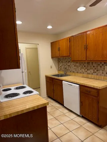 a kitchen with stainless steel appliances granite countertop a sink and cabinets