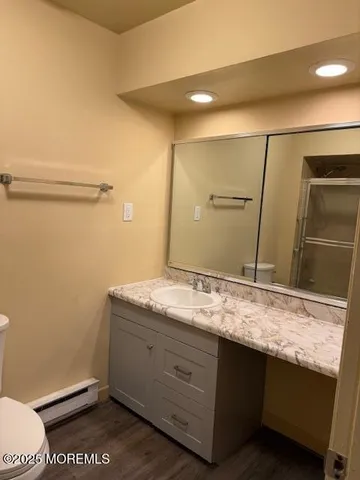 a bathroom with a granite countertop sink and a mirror