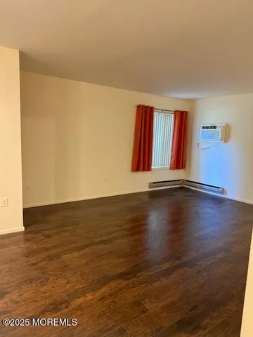 a view of room with hardwood floor and closet