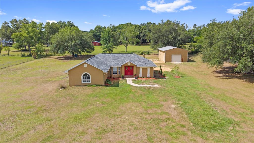 9917 Nelson Road Dade City, FL 33525 - Photo 7 of 40 a front view of a house with a yard and garage