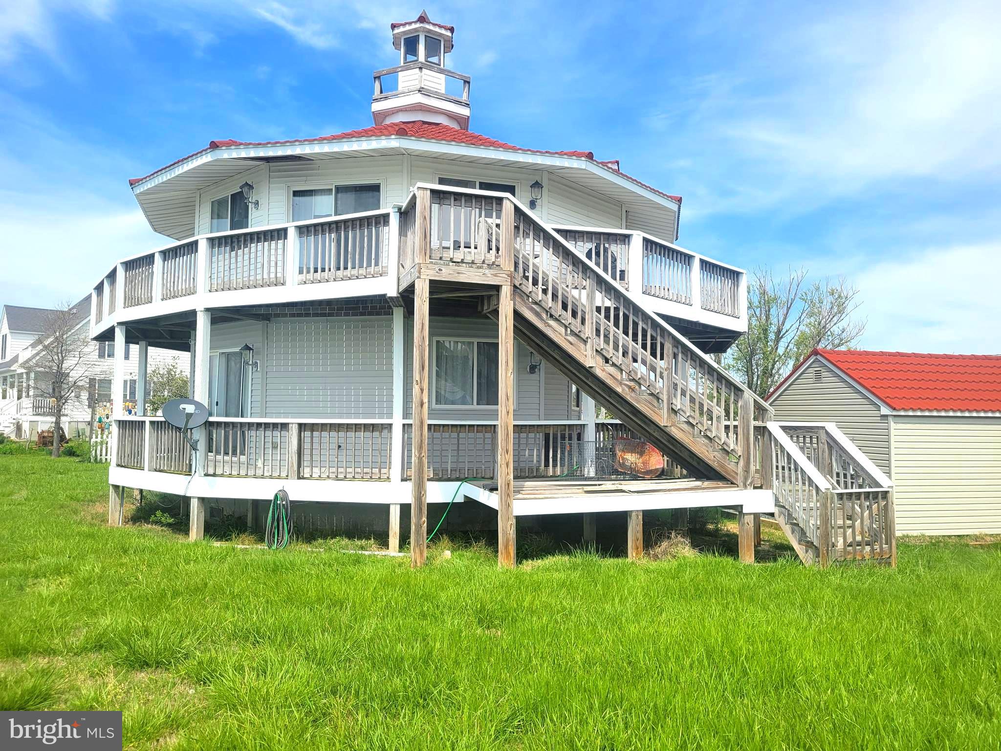 2452 Hoopers Island Road Fishing Creek, MD 21634 - Photo 2 of 3 a front view of a house with a yard