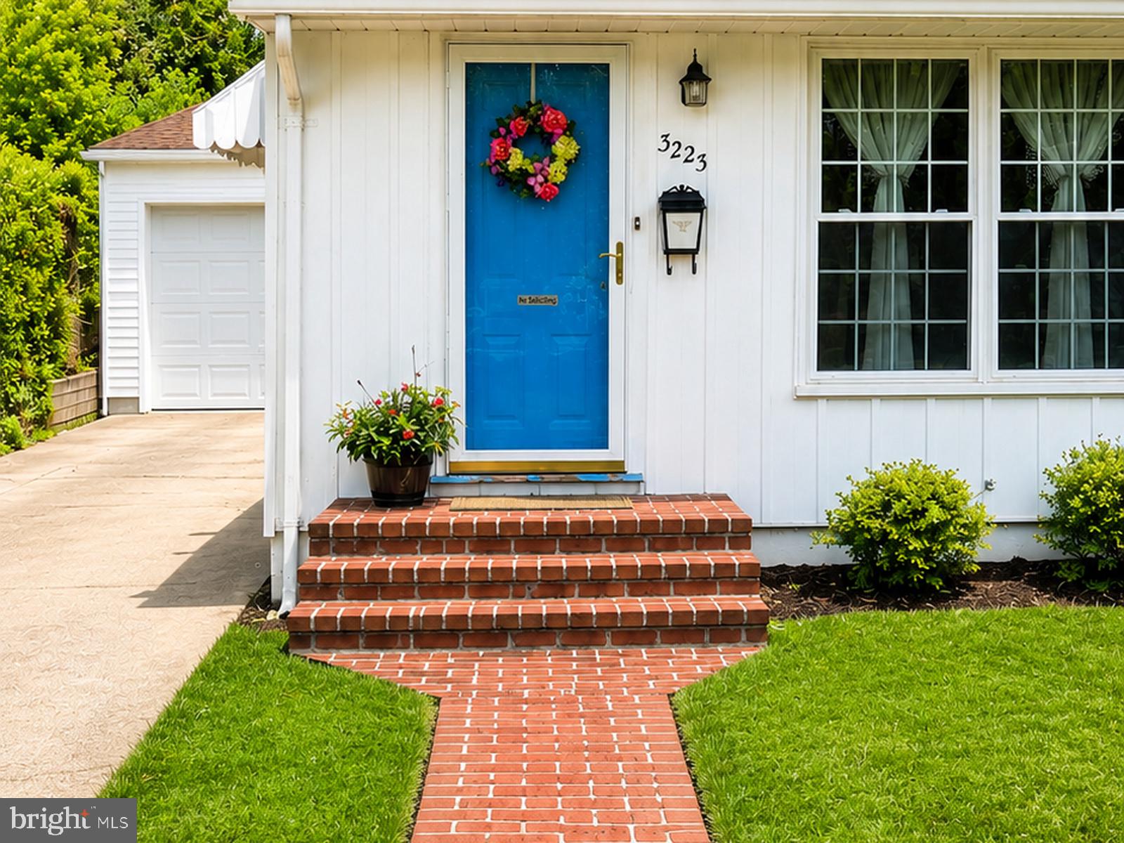 Charming entrance with vibrant blue door.