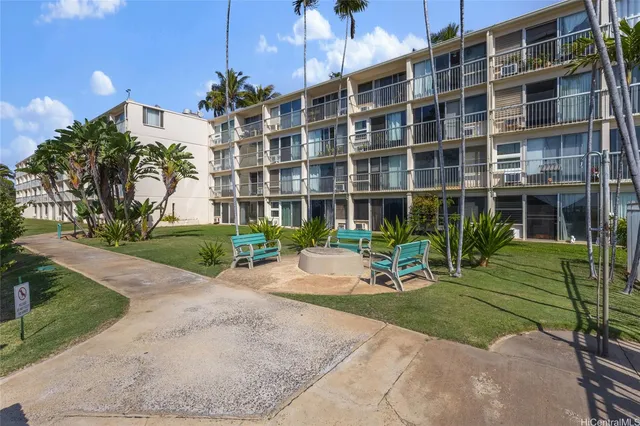 a view of a brick building with a yard in front of it