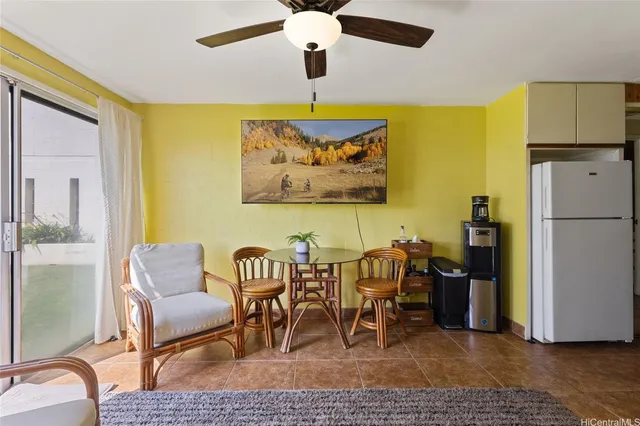 a view of a dining room with furniture and a chandelier