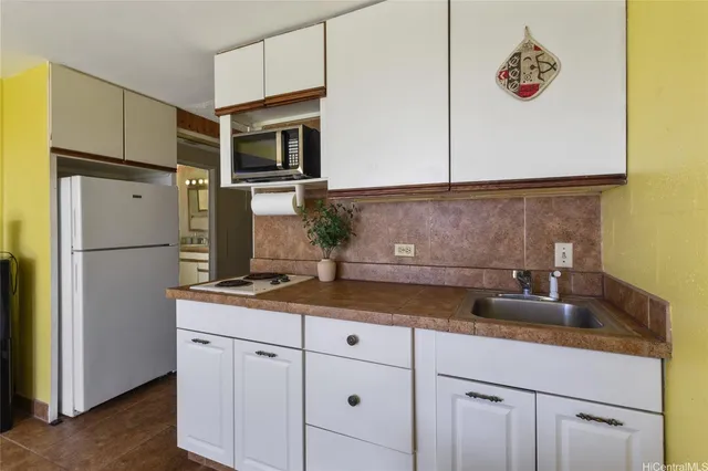 a kitchen with a sink and refrigerator
