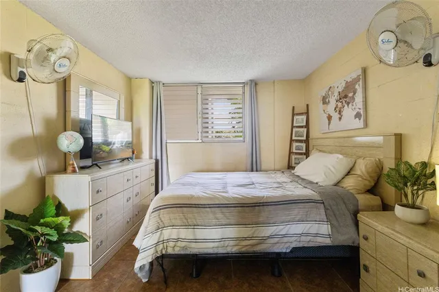 a bedroom with a bed and dresser with mirror