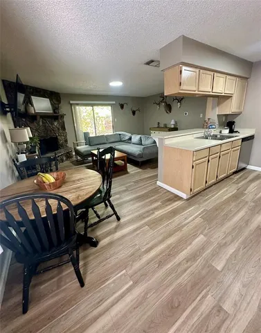 a living room with furniture a pool table and a fireplace