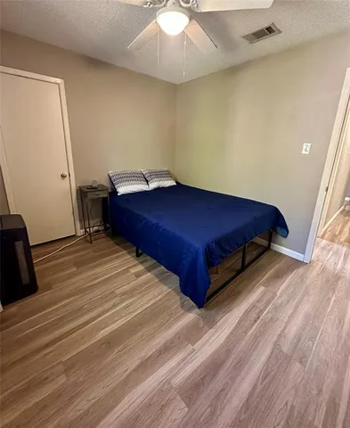 a bedroom with a bed and a mirror