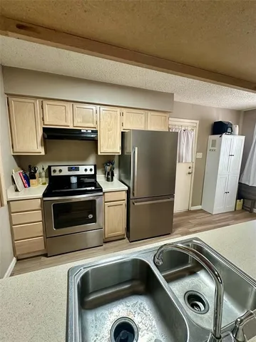 a kitchen with a refrigerator sink and stove