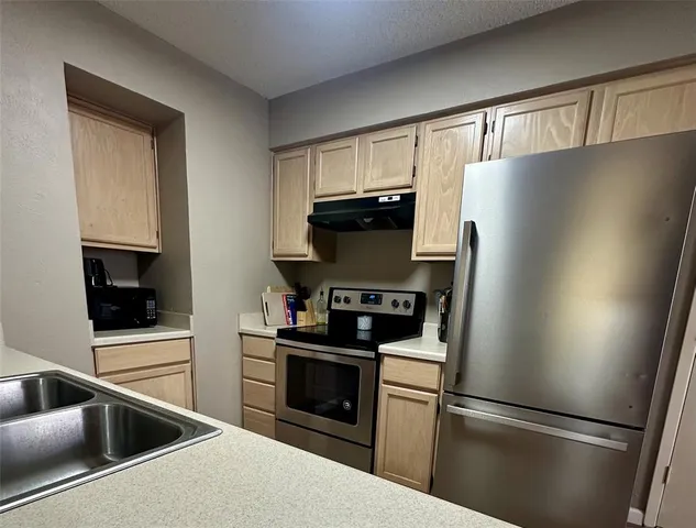 a kitchen with a refrigerator stove and microwave