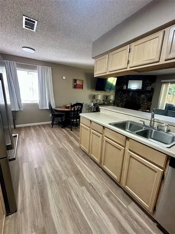 a kitchen with a sink stove and cabinets