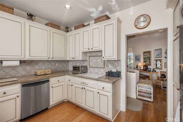 a kitchen with stainless steel appliances granite countertop a sink and cabinets