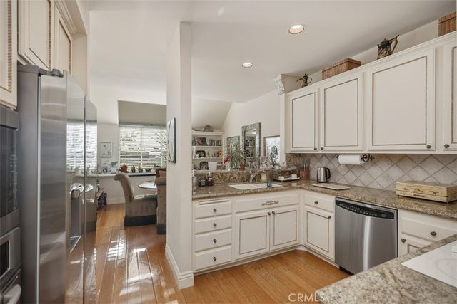 a kitchen with a sink refrigerator and cabinets