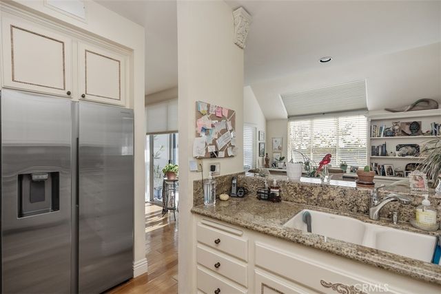 a kitchen with stainless steel appliances granite countertop a refrigerator and a sink