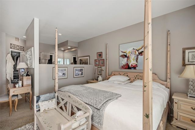 a bedroom with a bed and a view of kitchen