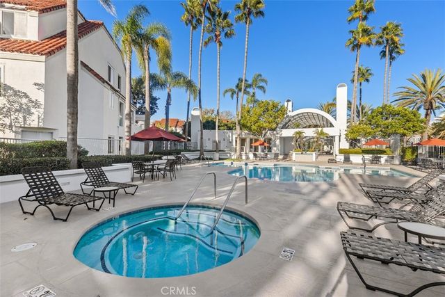 a view of a swimming pool with outdoor seating