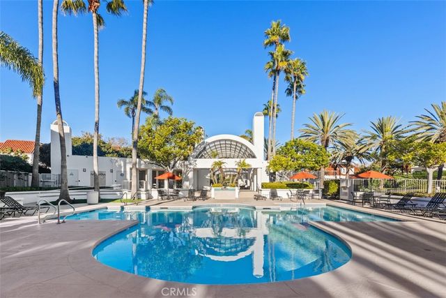 a view of a swimming pool with outdoor seating