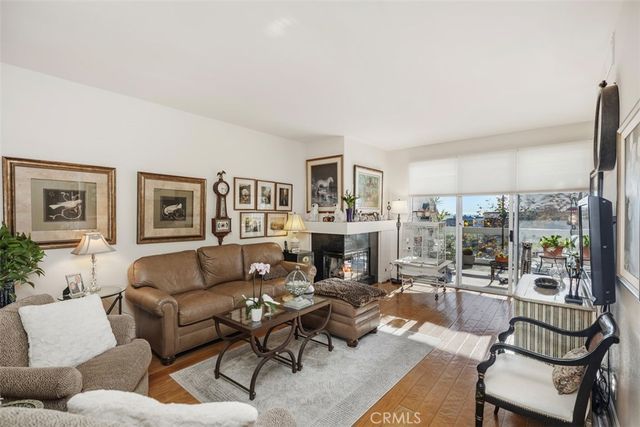a living room with furniture potted plant and a large window