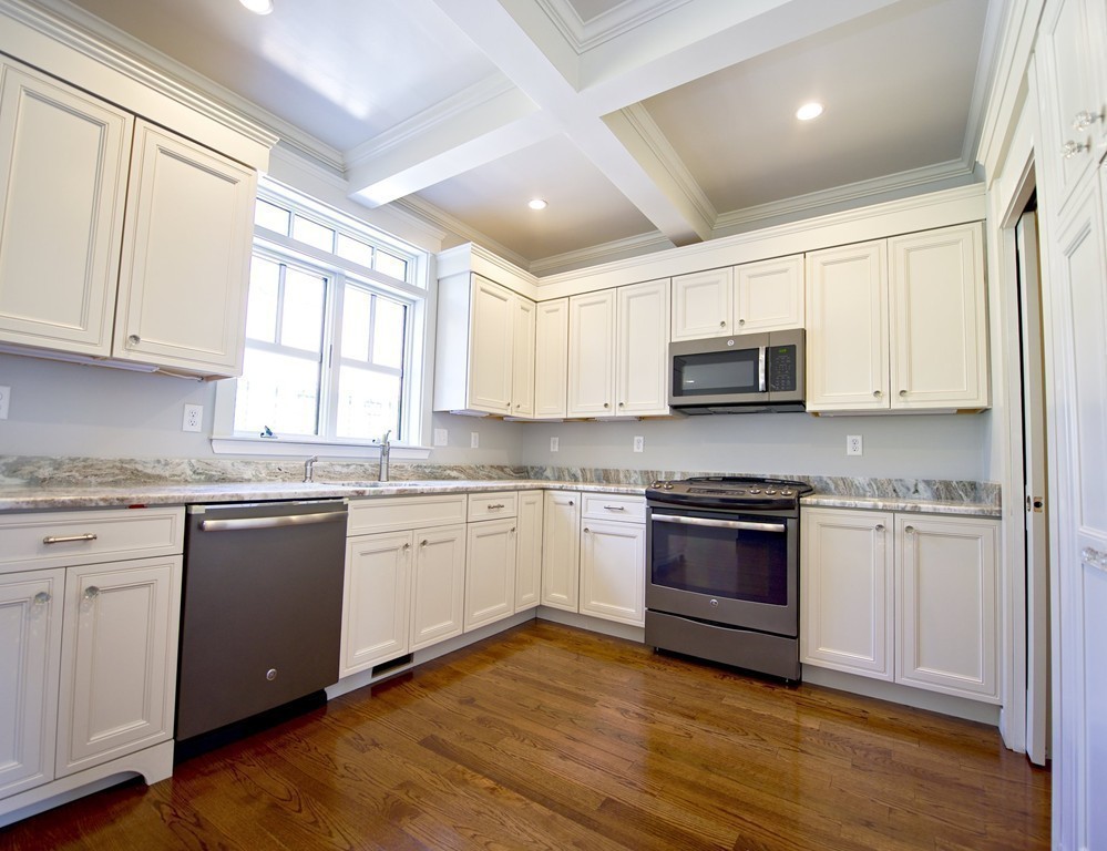180 First Parish Road Scituate, MA 02066 - Photo 11 of 26 a kitchen with granite countertop appliances cabinets and a wooden floor