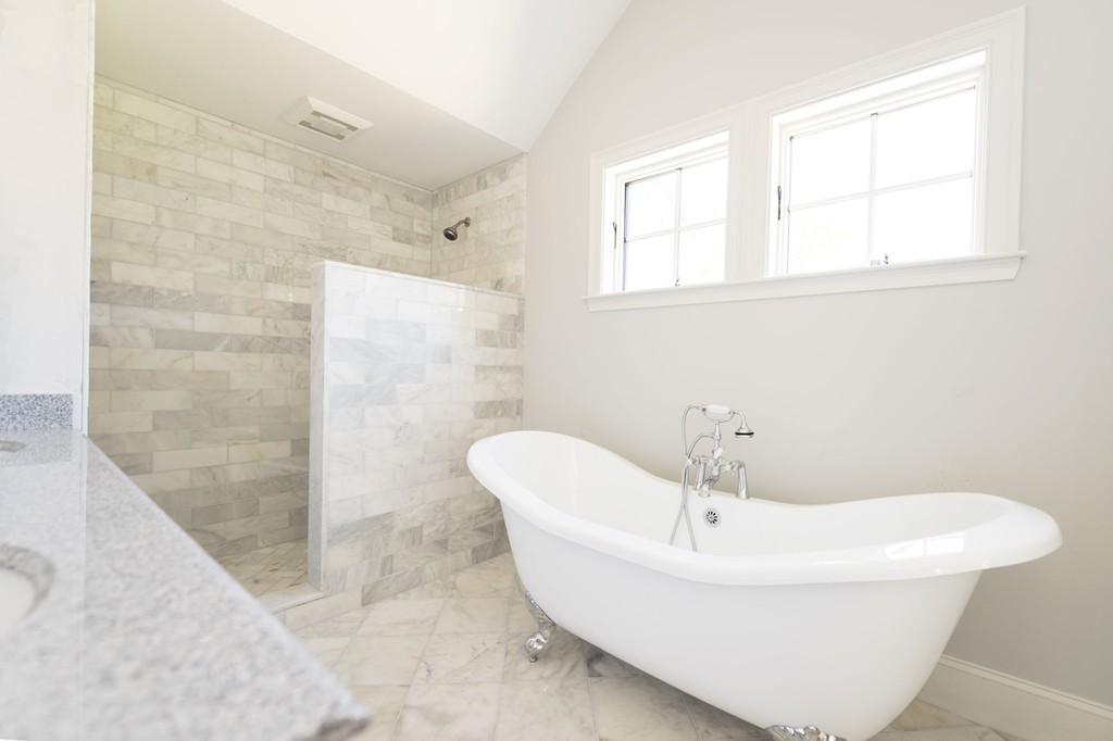 180 First Parish Road Scituate, MA 02066 - Photo 17 of 26 a white bath tub sitting in a bathroom