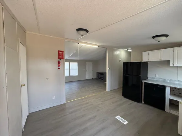 a view of a kitchen with a sink and a refrigerator