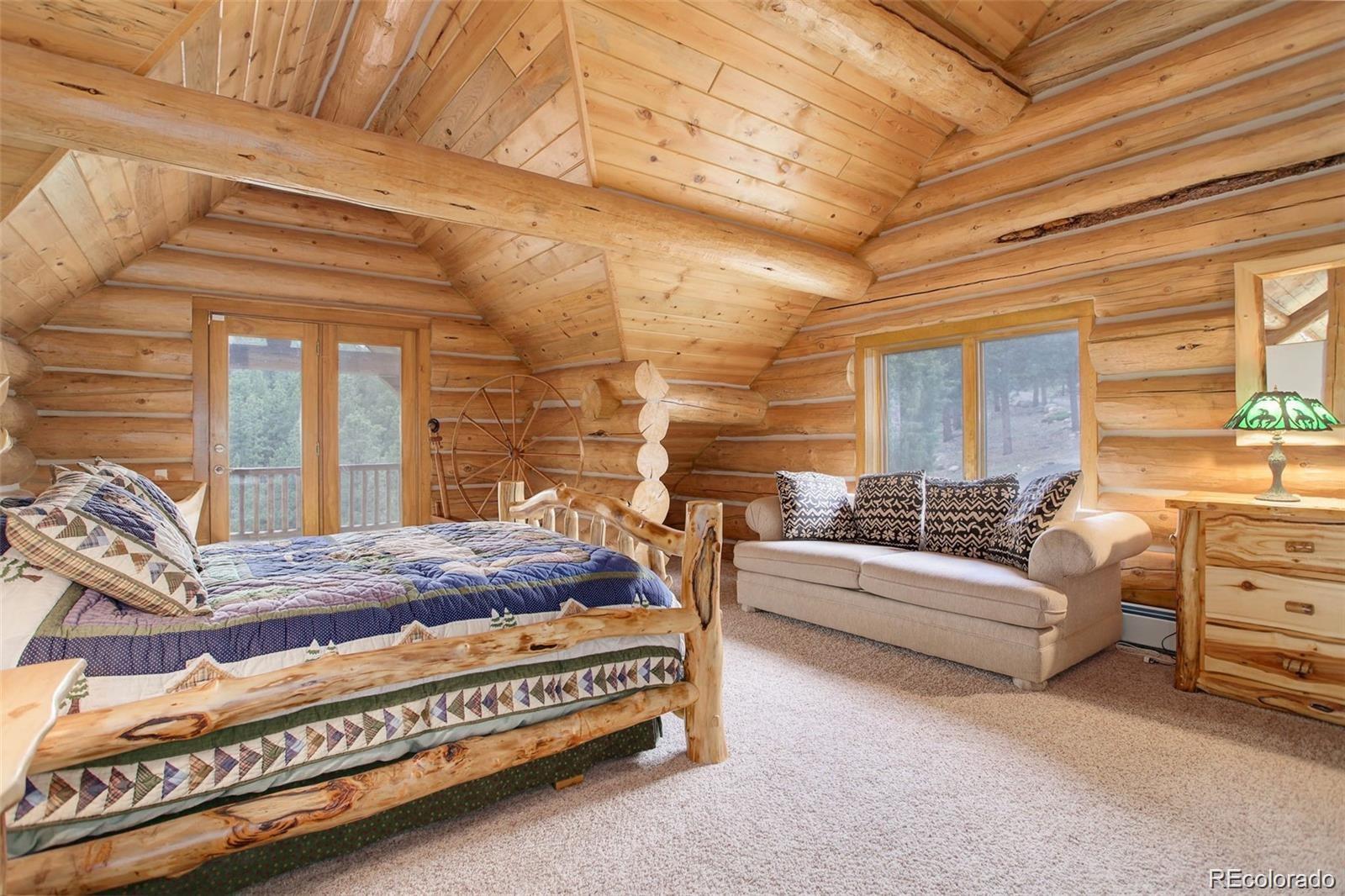 256 Blueberry Drive Bailey, CO 80421 - Photo 28 of 49 a bed room with a bed and a couch