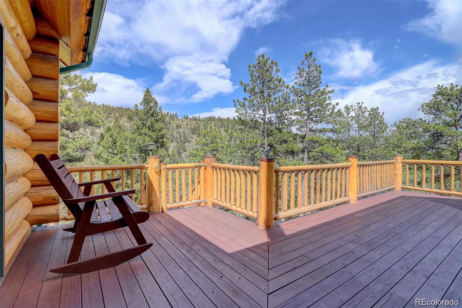 256 Blueberry Drive Bailey, CO 80421 - Photo 44 of 49 a view of a chairs on wooden deck