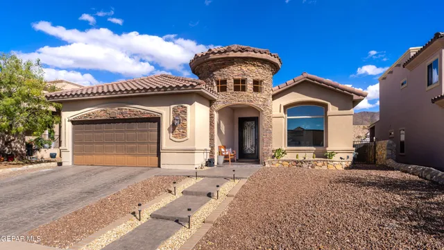 a view of a house with a yard and garage