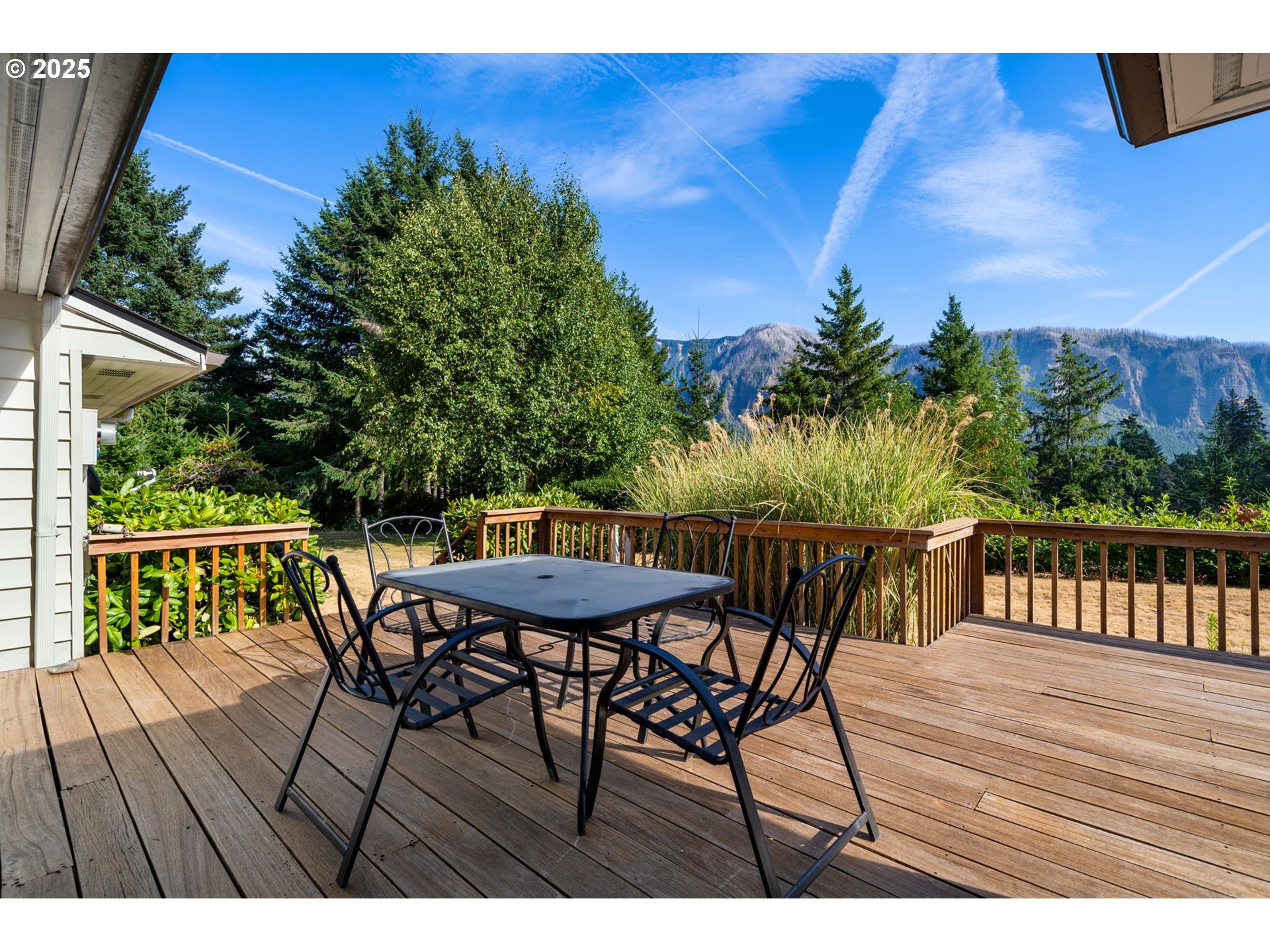 402 Skelton Road Stevenson, WA 98648 - Photo 15 of 48 a view of a roof deck with table and chairs with wooden floor and fence