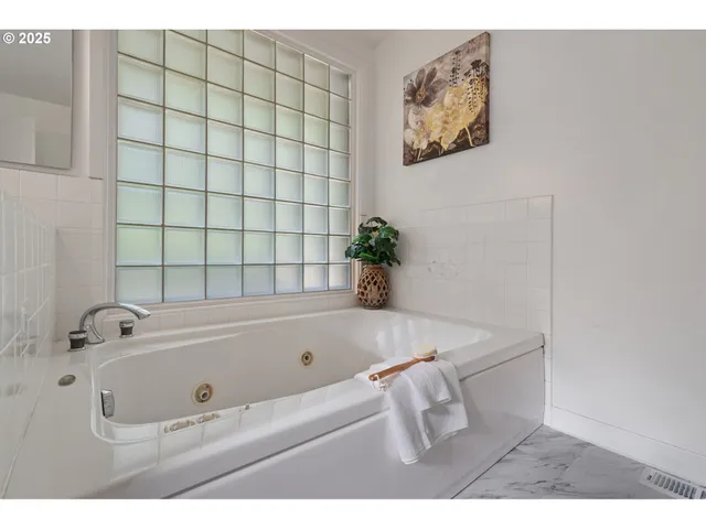 a view of a hallway with wooden floor and a potted plant