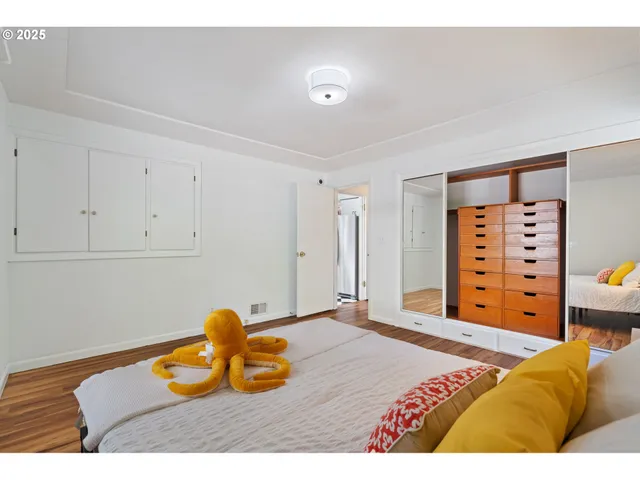 a living room with furniture a large window and a potted plant